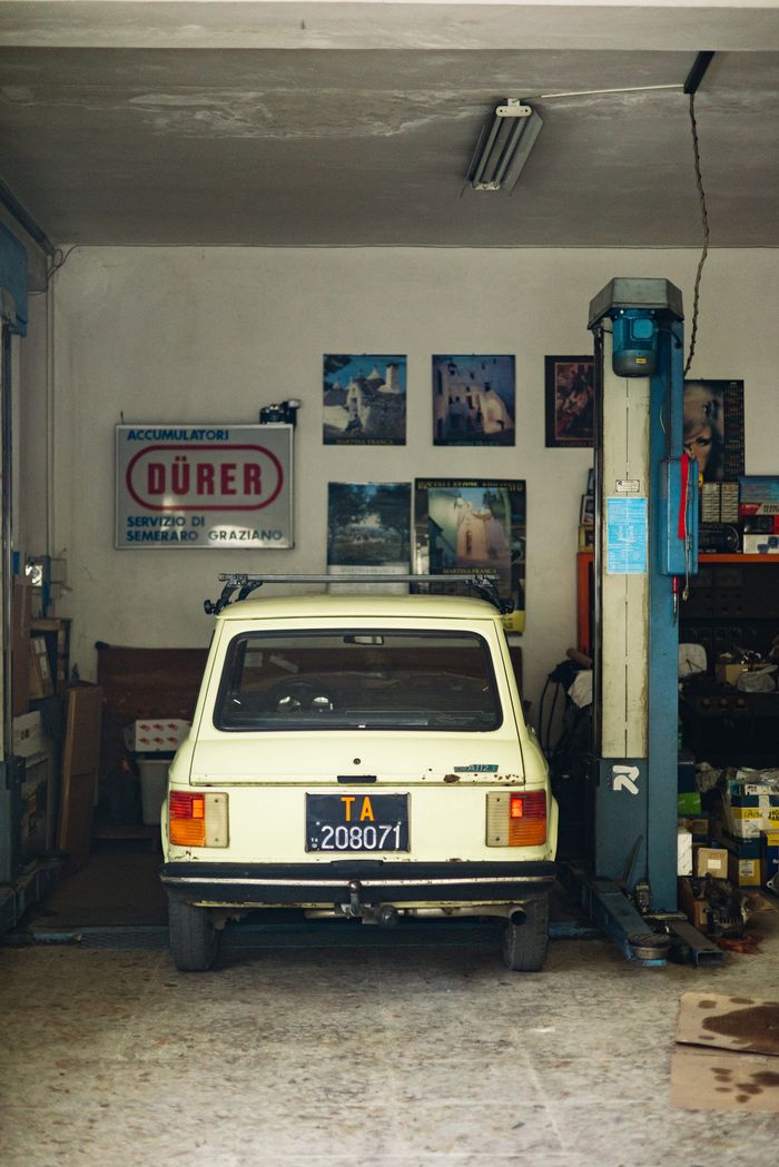 Back view of a vintage Autobianchi in a Martina Franca workshop.